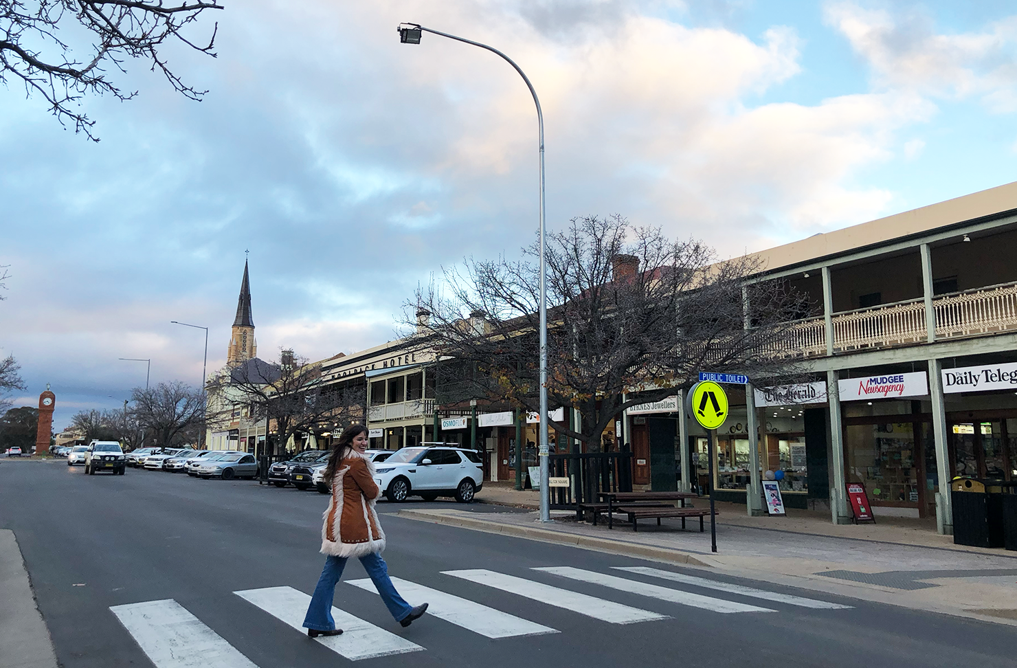 Woman walking across a crossing in the town of Mudgee.